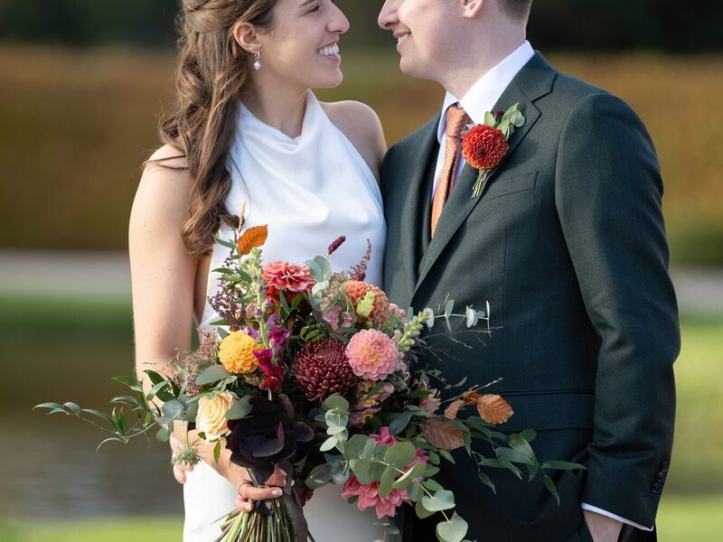 Ellie and Jack with a wild bridal bouquet of dahlias, roses and autumn foliage