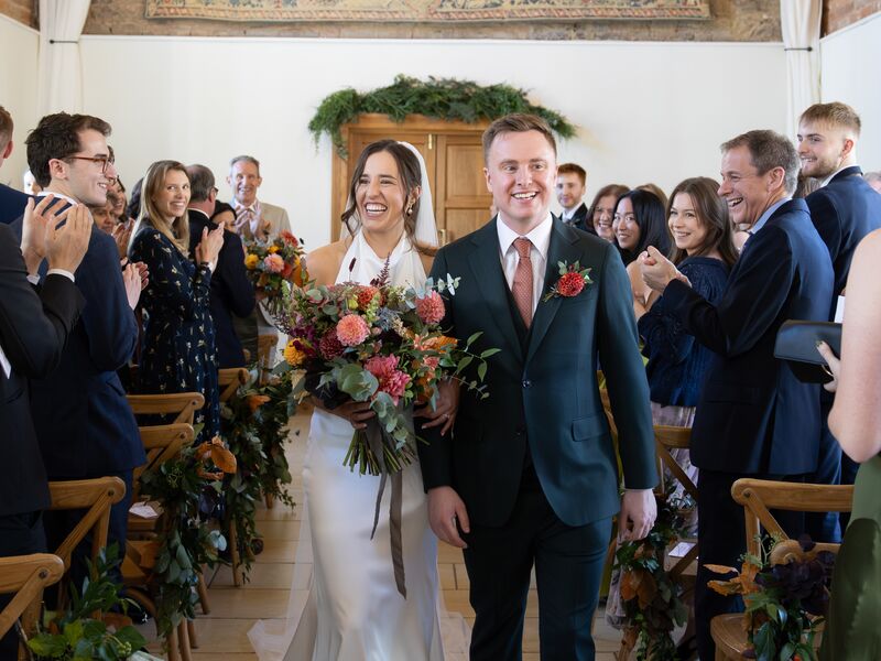 Ellie and Jack walking through the ceremony room at The Barns at Delbury Hall