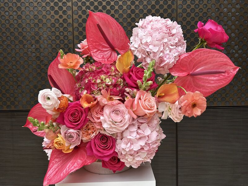 Charlotte and Kane’s pink and coral wedding flower arrangement Close-up of sculptural pink, coral and orange wedding flowers with anthuriums and hydrangeas