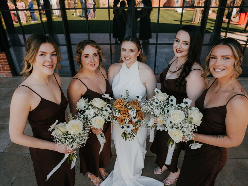 Sophie and her bridesmaids with their spring wedding bouquets — Photography by Linas Sophie and her bridesmaids holding white and toffee wedding bouquets with brown satin dresses