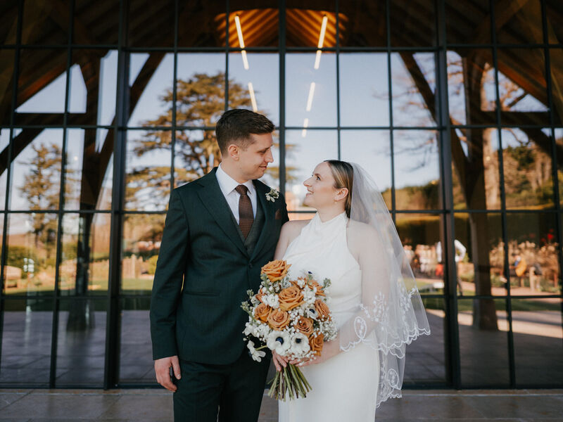 Sophie and Grant’s modern March wedding at The Post Barn — Photography by Linas Sophie and Grant outside The Post Barn with Sophie’s toffee rose and white anemone bouquet
