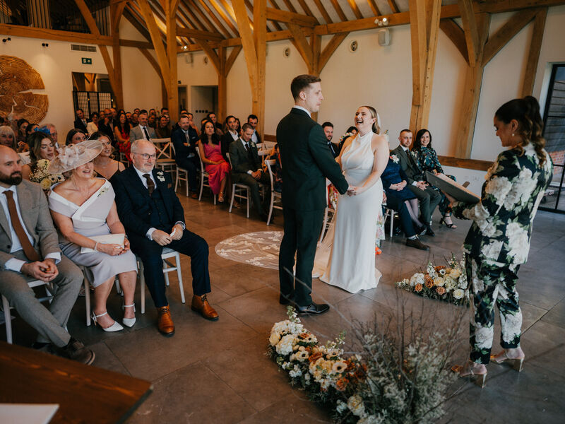 Spring wedding ceremony flowers at The Post Barn — Photography by Linas Sophie and Grant’s ceremony framed by sculptural white and toffee flowers at The Post Barn