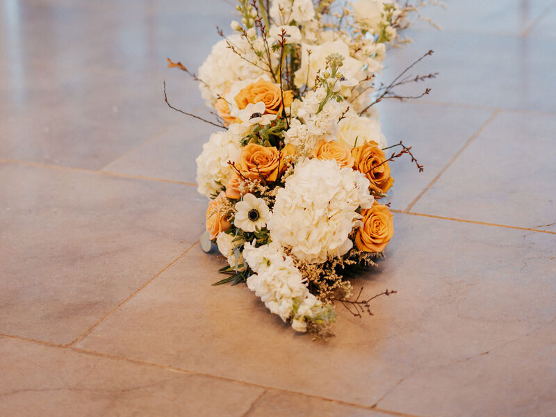 Toffee and white spring wedding floral palette at The Post Barn — Photography by Linas Sculptural ceremony flowers in toffee and white with hydrangeas and Salix branches at The Post Barn