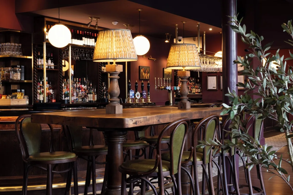 Warmly lit bar interior at The Royal Forest in Chingford