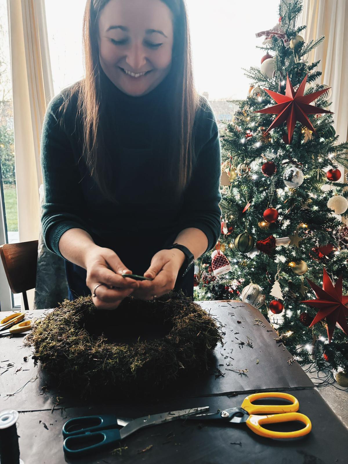Alex preparing natural foliage during a Christmas wreath workshop